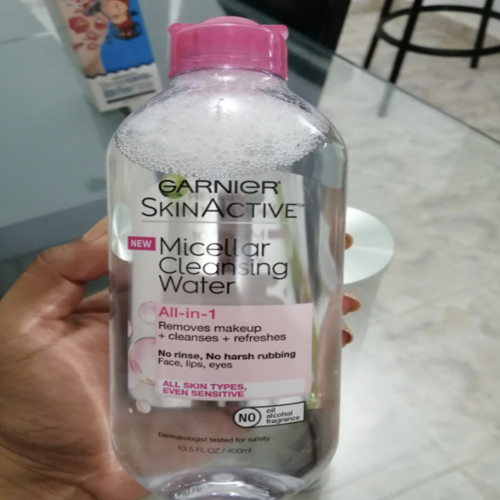 Reviewer holding bottle of micellar water