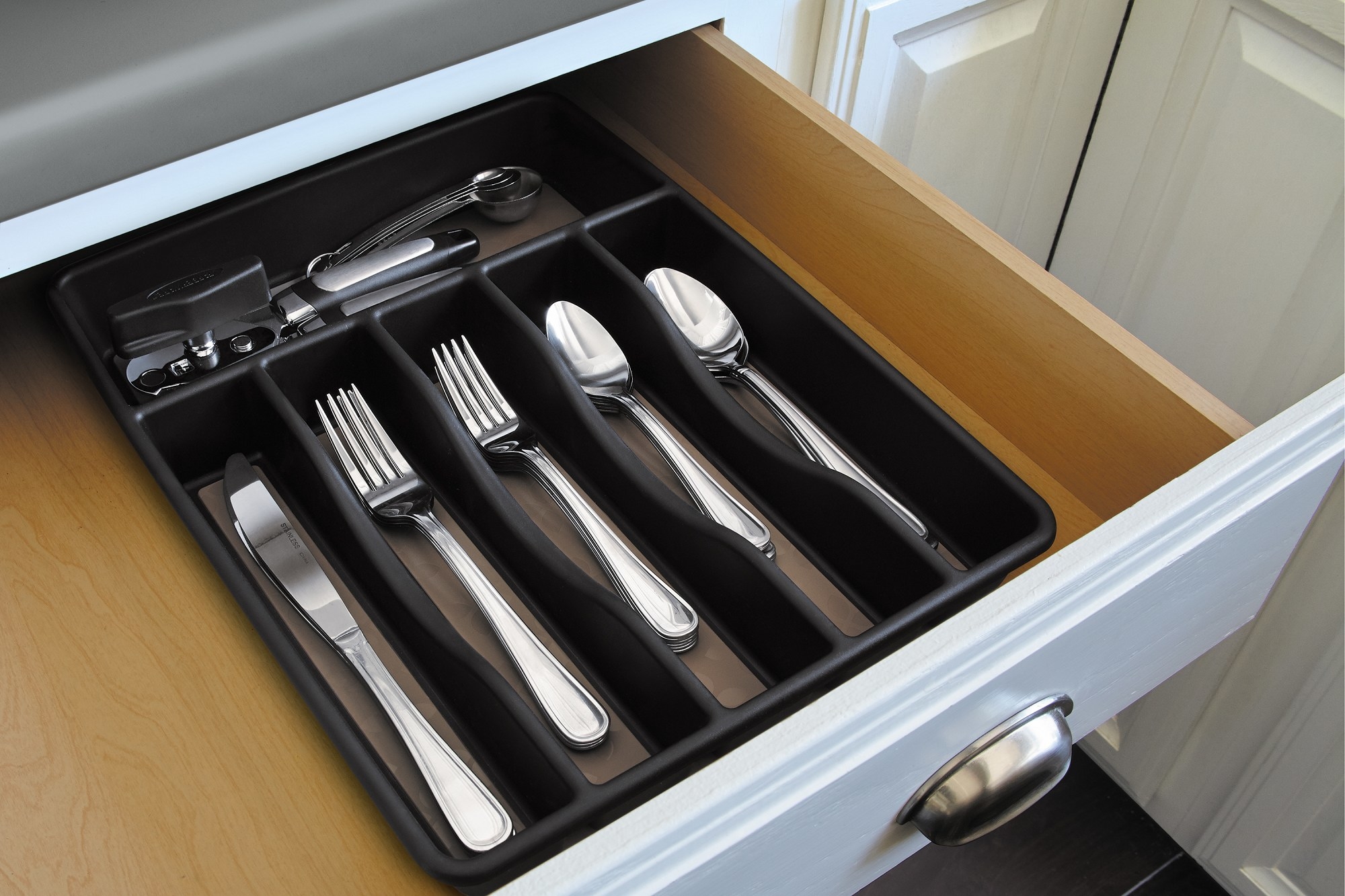The tray inside a drawer with cutlery neatly organized