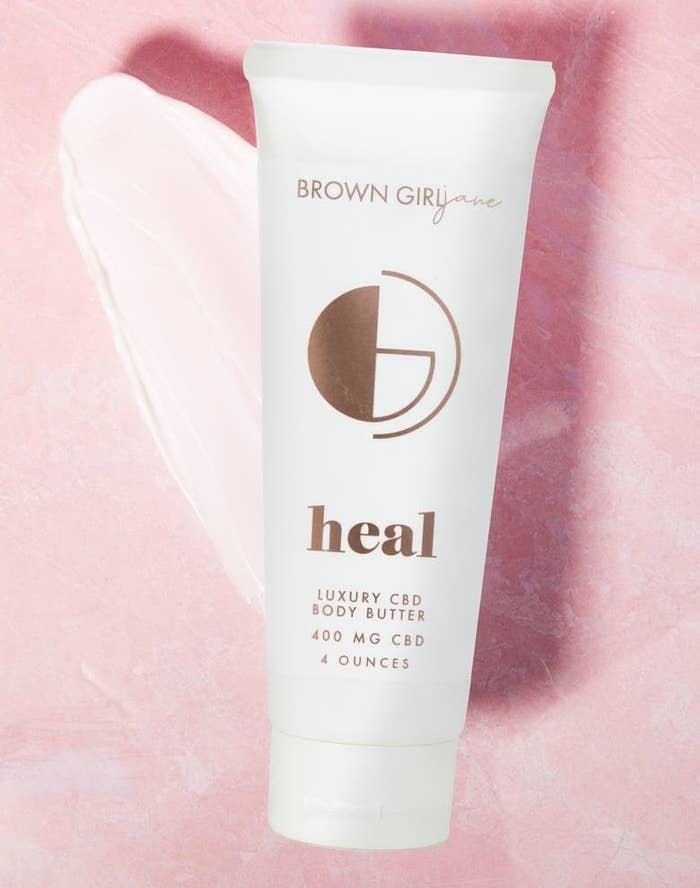 A tube of Brown Girl Jane Healy Whipped Body Butter against a pink background 