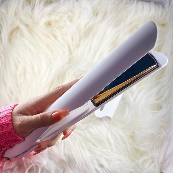 A person holding the flat iron