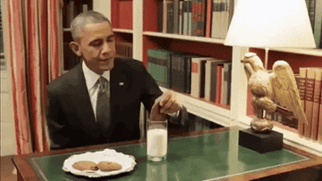 President Obama dipping a cookie into milk. 