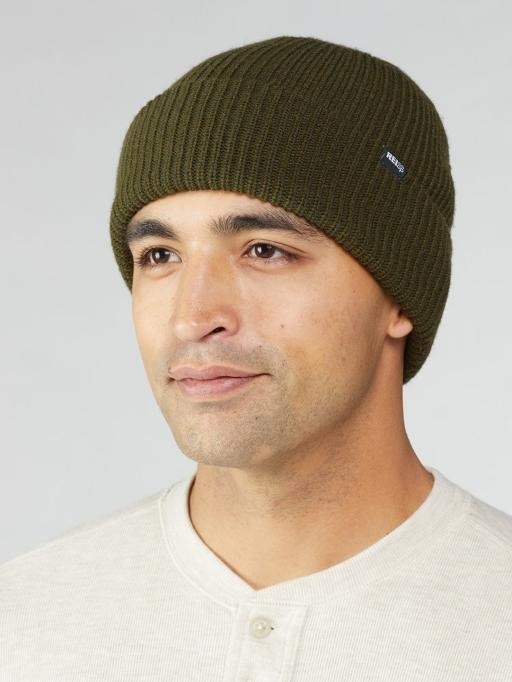 Model wears green ribbed cap with a white polo shirt