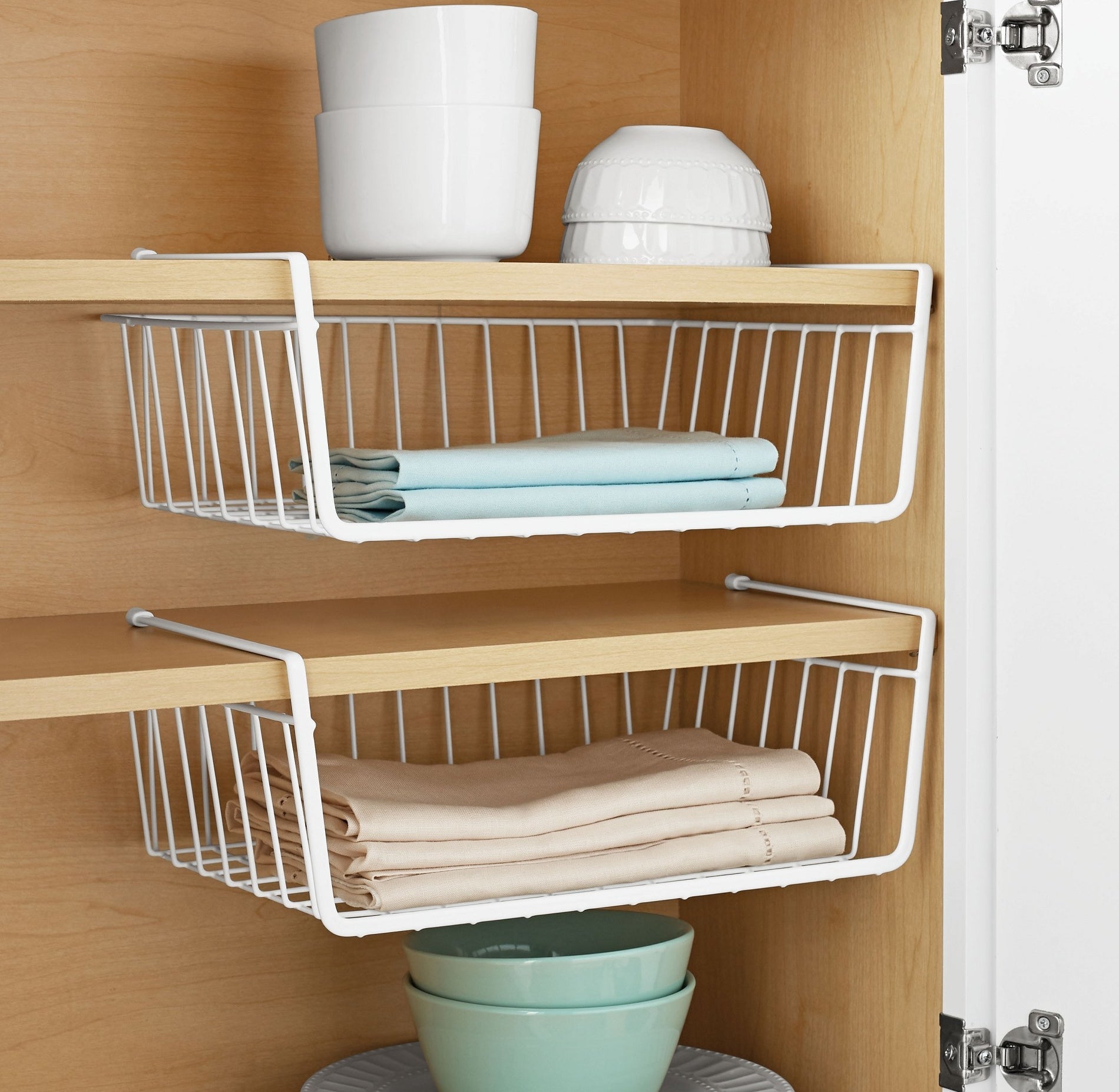 The baskets hung from cabinet shelves