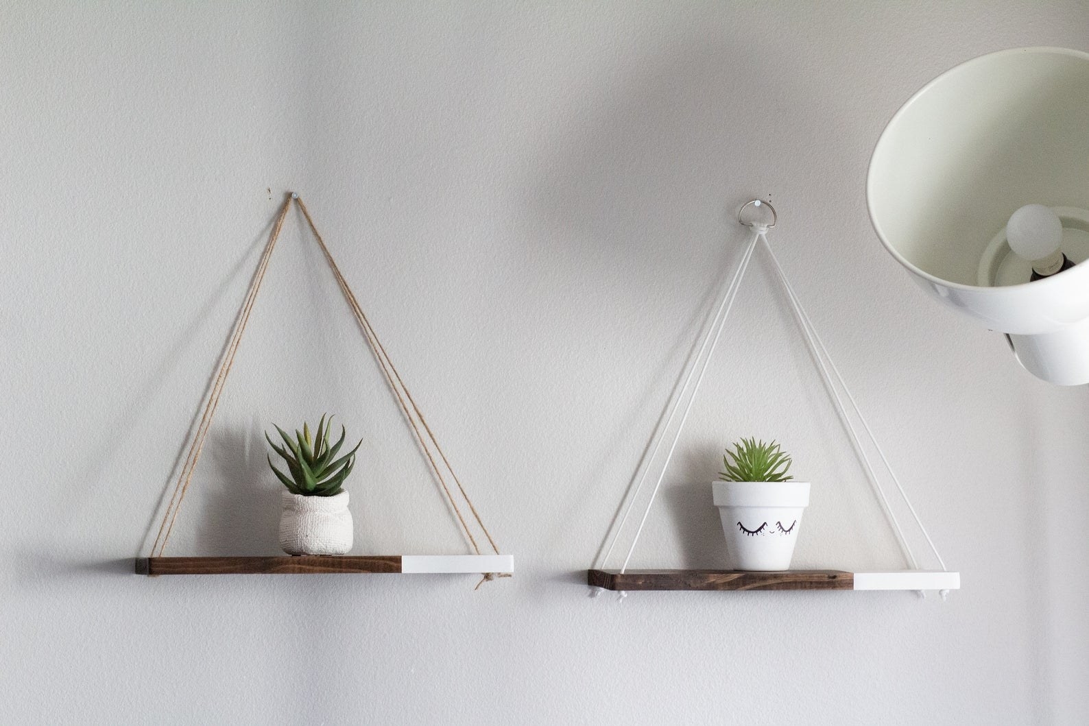 two hanging wood shelves with planters on top