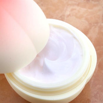 the peach hand cream opened showing the creamy texture