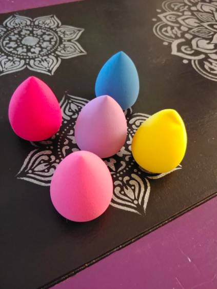 a reviewer photo of the five colorful makeup sponges