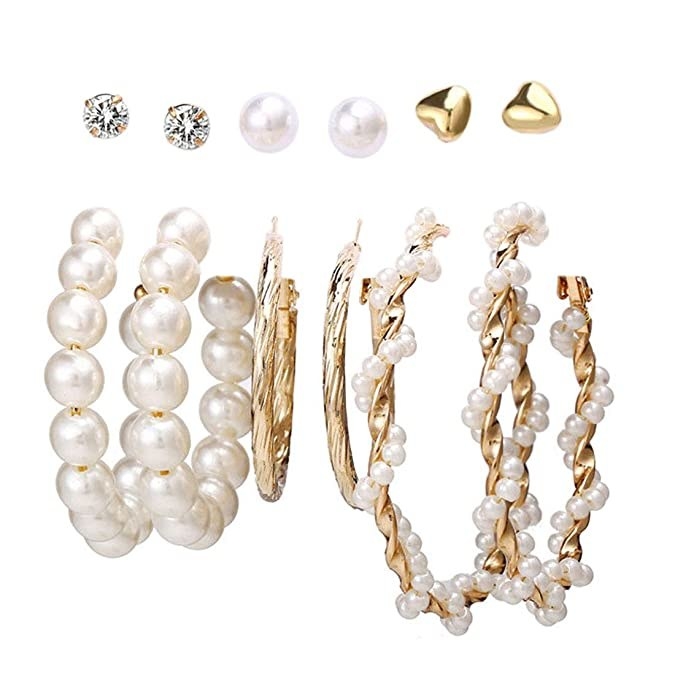 Assorted set of gold and pearl hoop earrings.