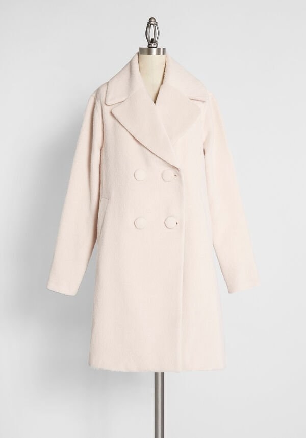 the ivory coat with four large buttons in the center
