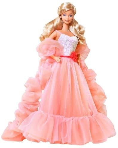 A Barbie wearing a peach ruffled dress and boa with silver sparkly top