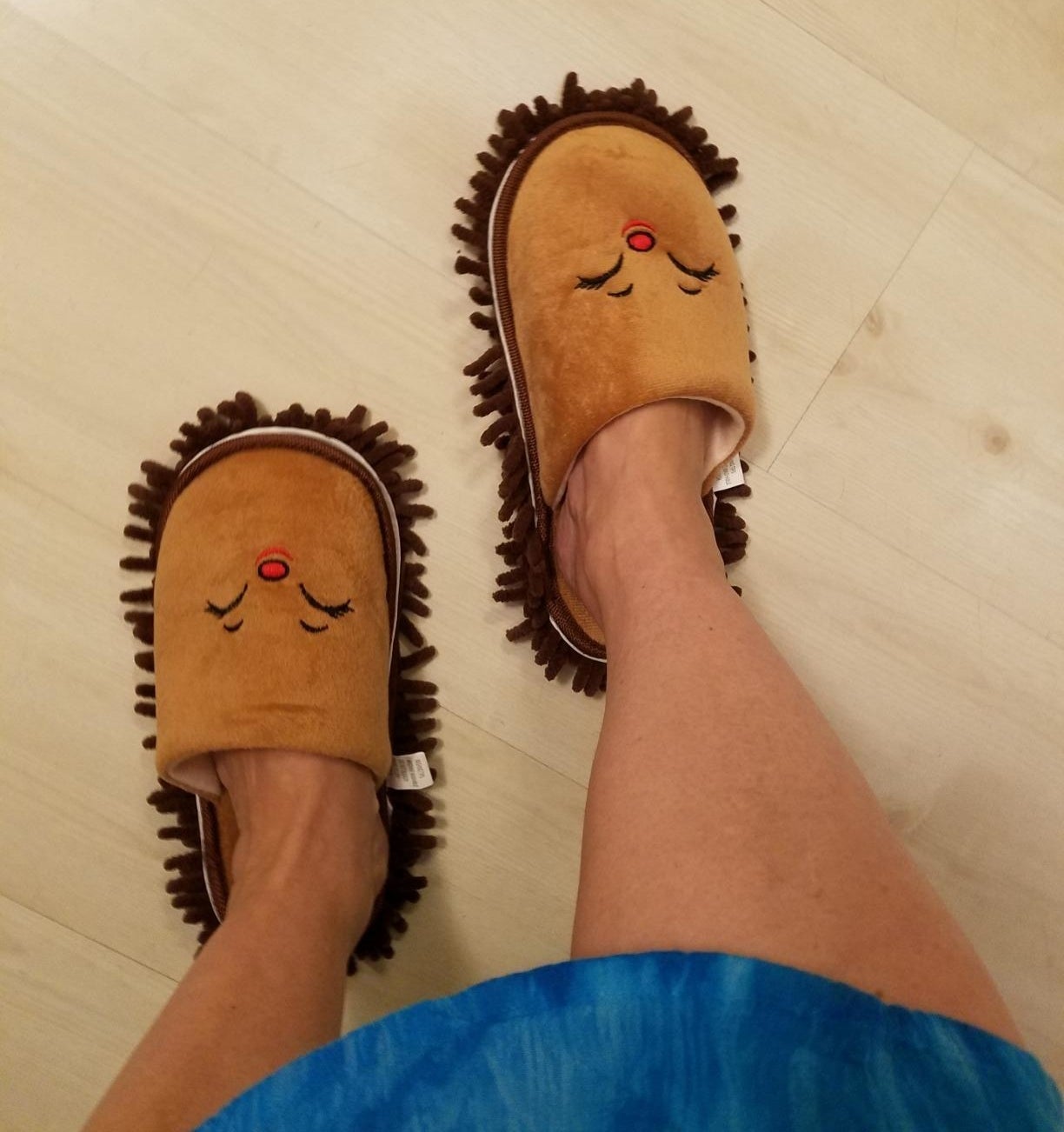 reviewer wearing mop slippers on their hardwood floors 