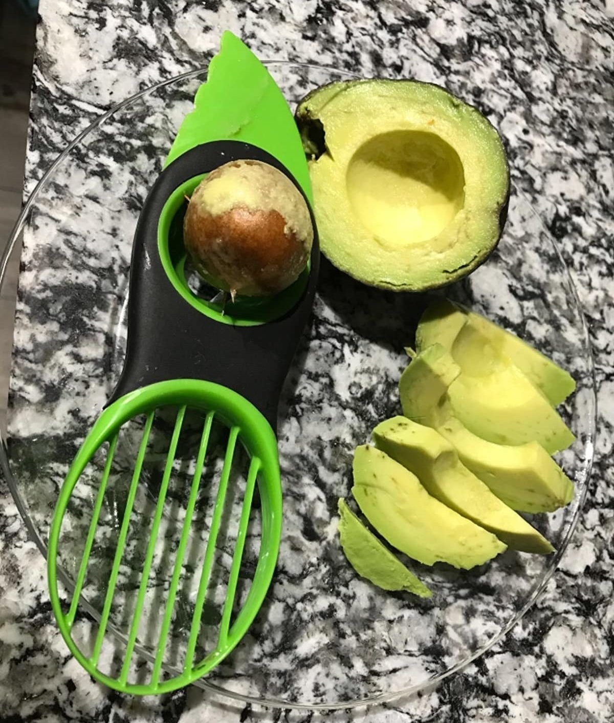reviewer photo showing avocado slicing tool with the pit remover and perfect slices of avocado 