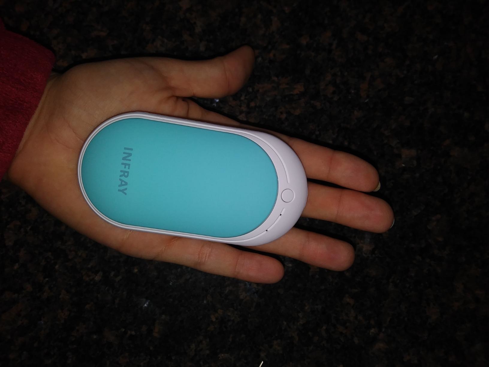 reviewer photo showing the blue hand warmer in a hand