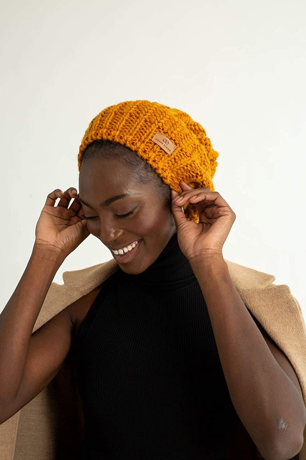 a model wearing the beanie in a mustard yellow color