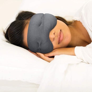 Model wearing the eye mask while lying on their side