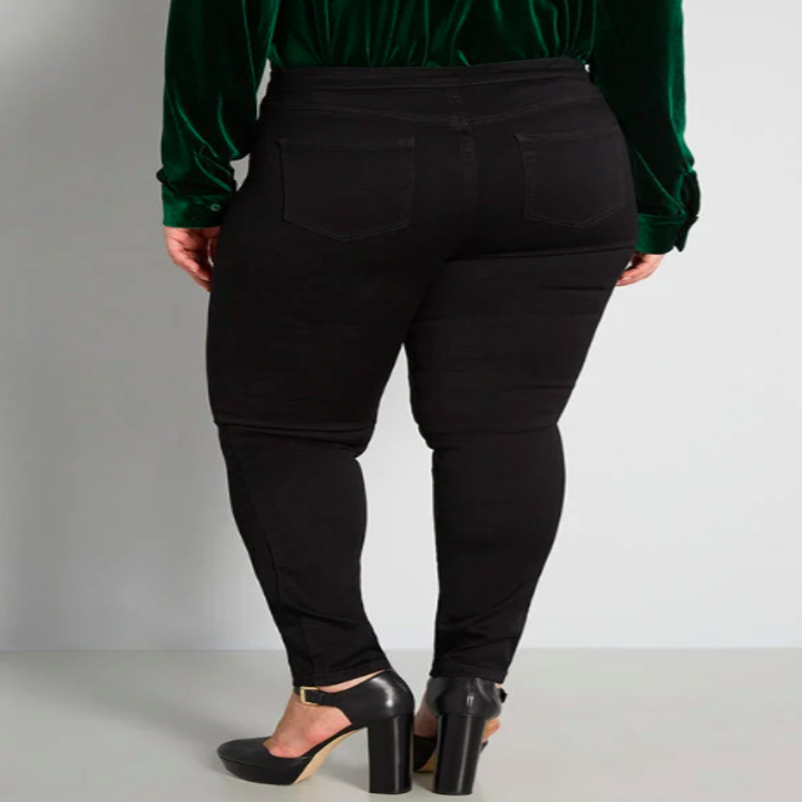 the same model but showing the back of the high-waisted pants