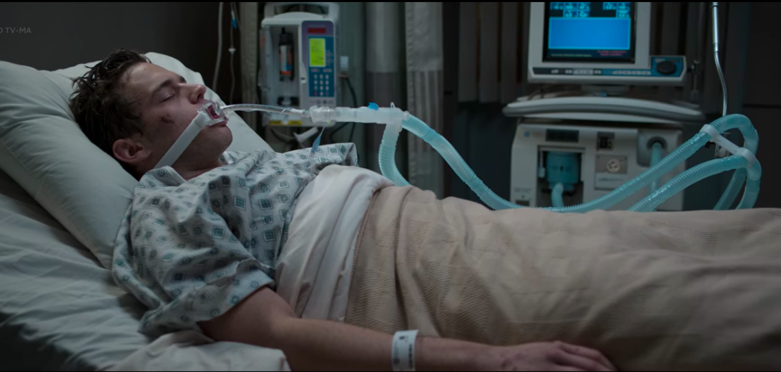 Justin Foley lying in a hospital bed