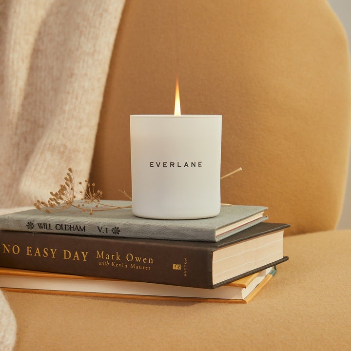 White cozy cabin candle that says Everlane on it