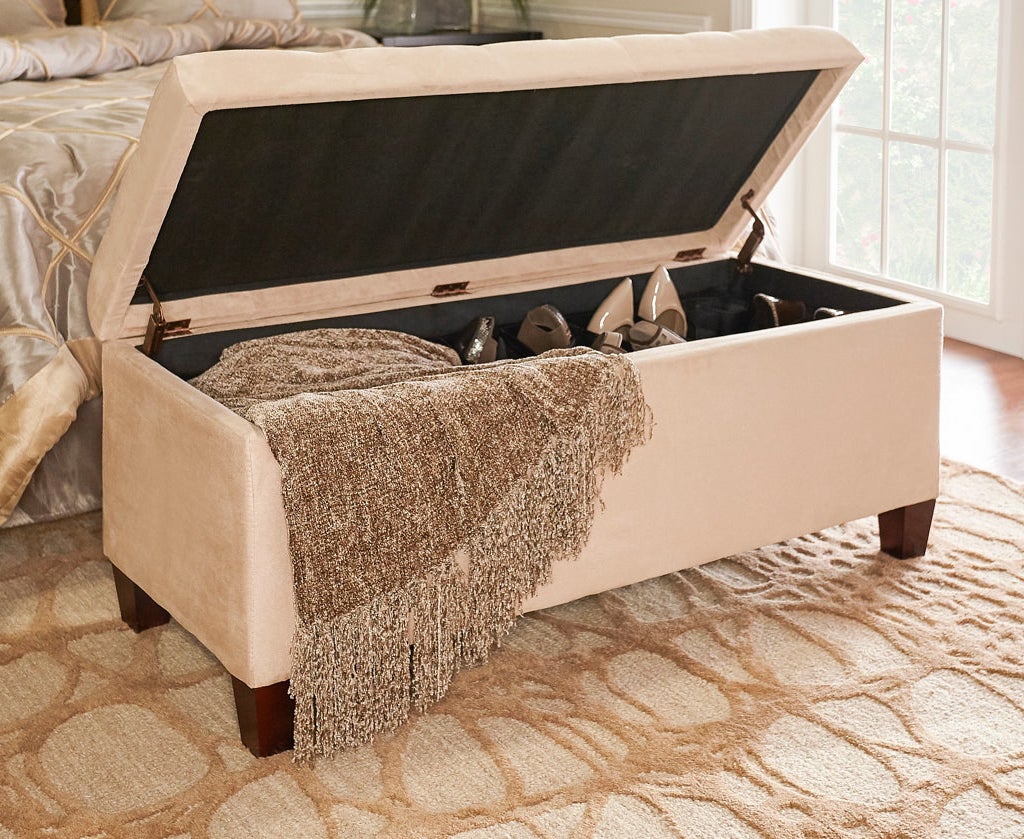 a tan storage ottoman with the top open