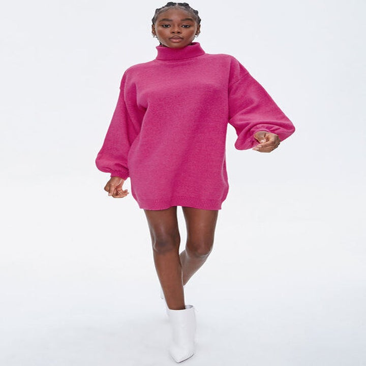 Model wearing pink puff-sleeve turtleneck mini dress in pink