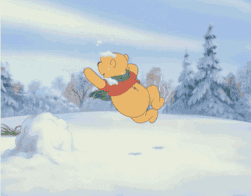 Winnie The Pooh wearing a green scarf and playing in the snow 