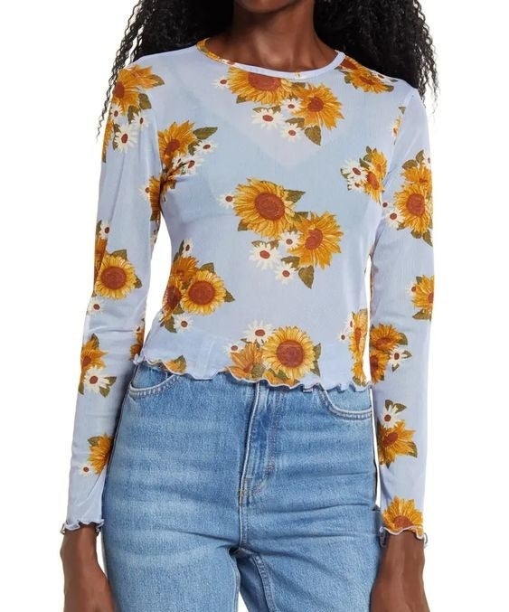 Model wearing the light blue mesh shirt with sunflower pattern 