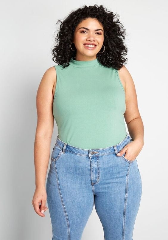 Model wearing the sleeveless top in teal 