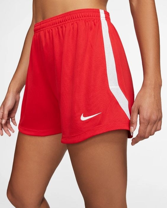 Model wearing the red workout shorts with white mesh side stripes 