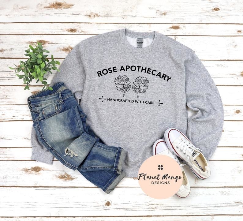 The sweatshirt with the rose apothecary logo and text &quot;handcrafted with care&quot;