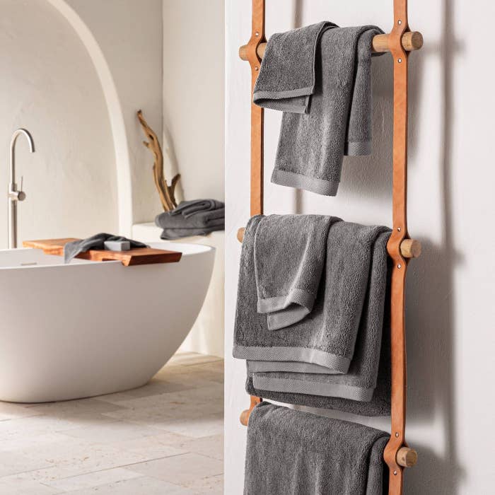 Dark Gray towels on a brown wood towel rack