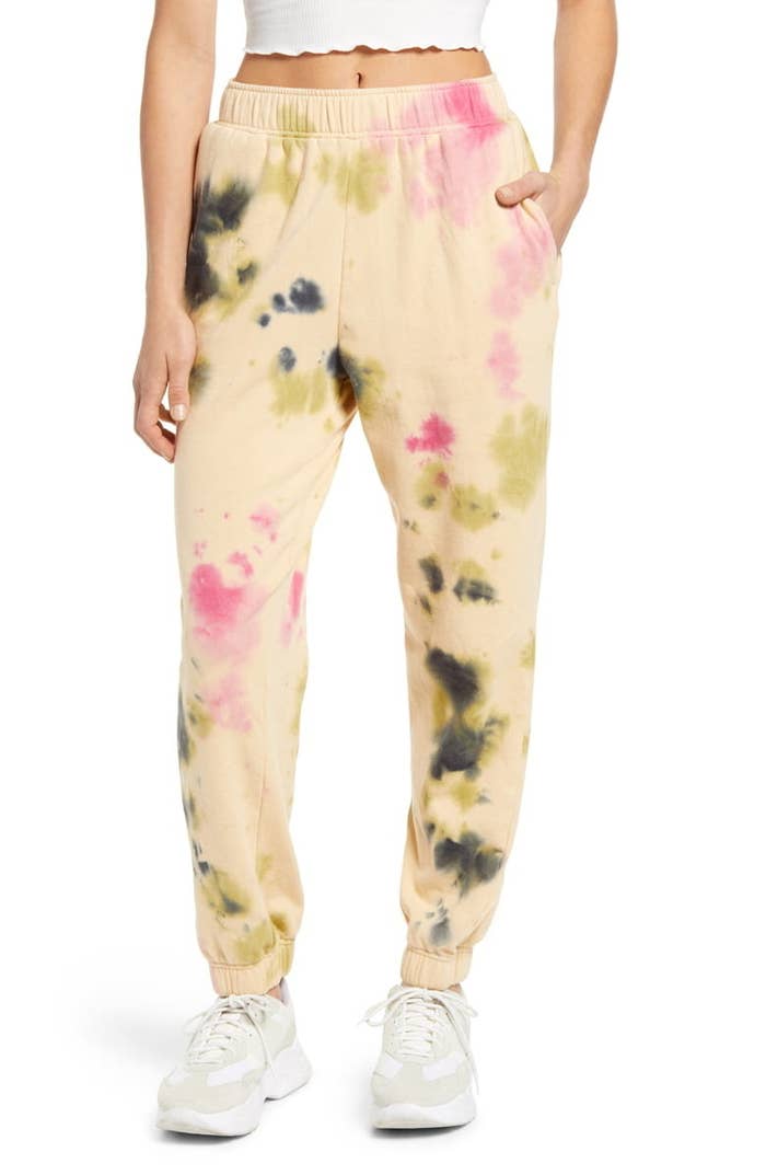 model wearing the yellow sweatpants with gray and pink tie dye
