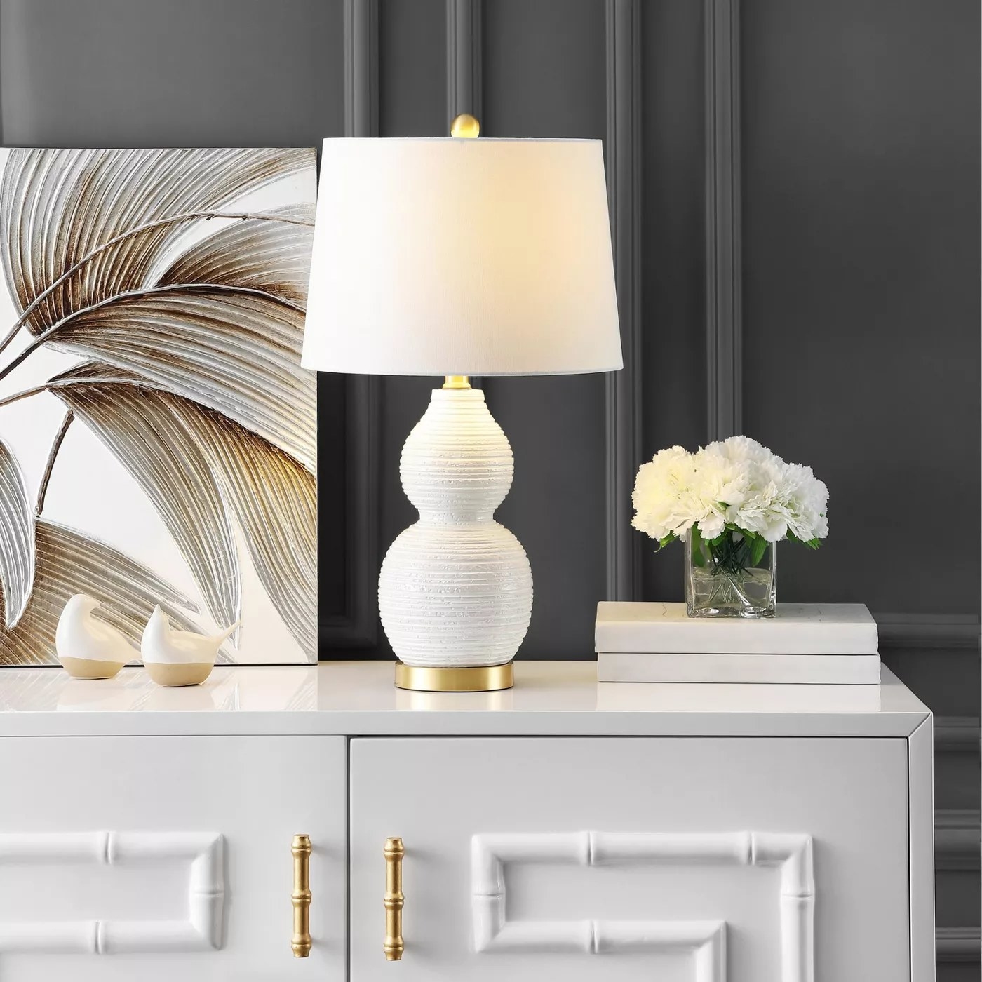 The white table lamp with gold accents
