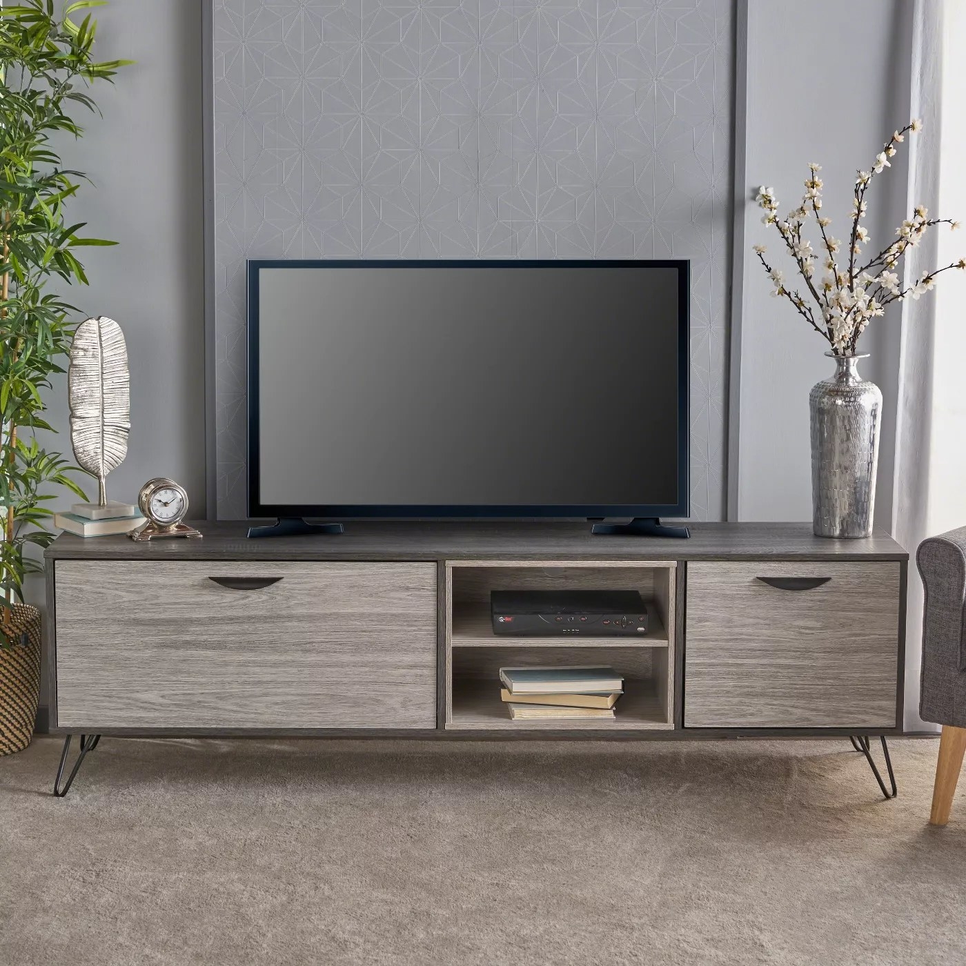 The gray and black mid-century TV stand