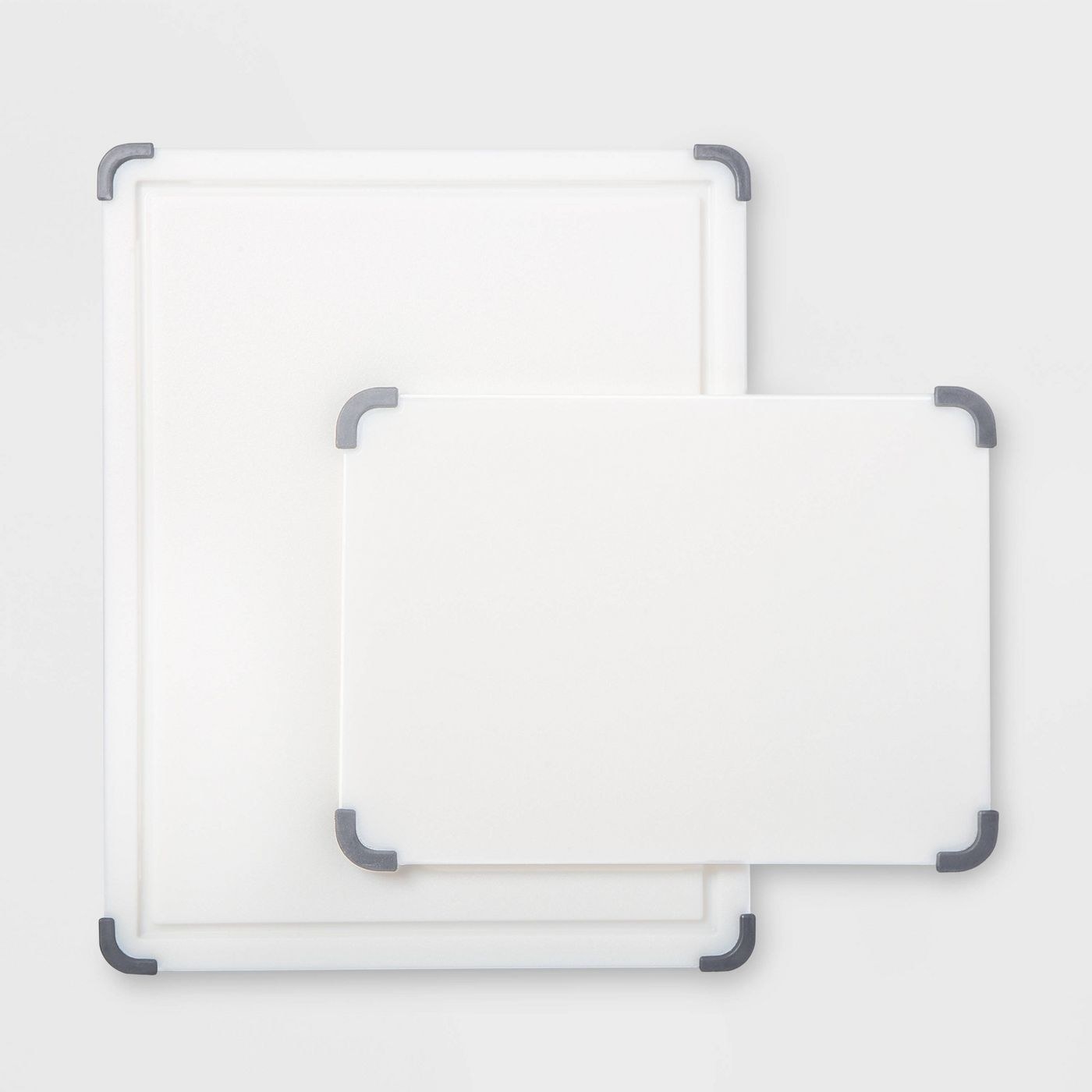 two plastic white cutting boards, one medium one small