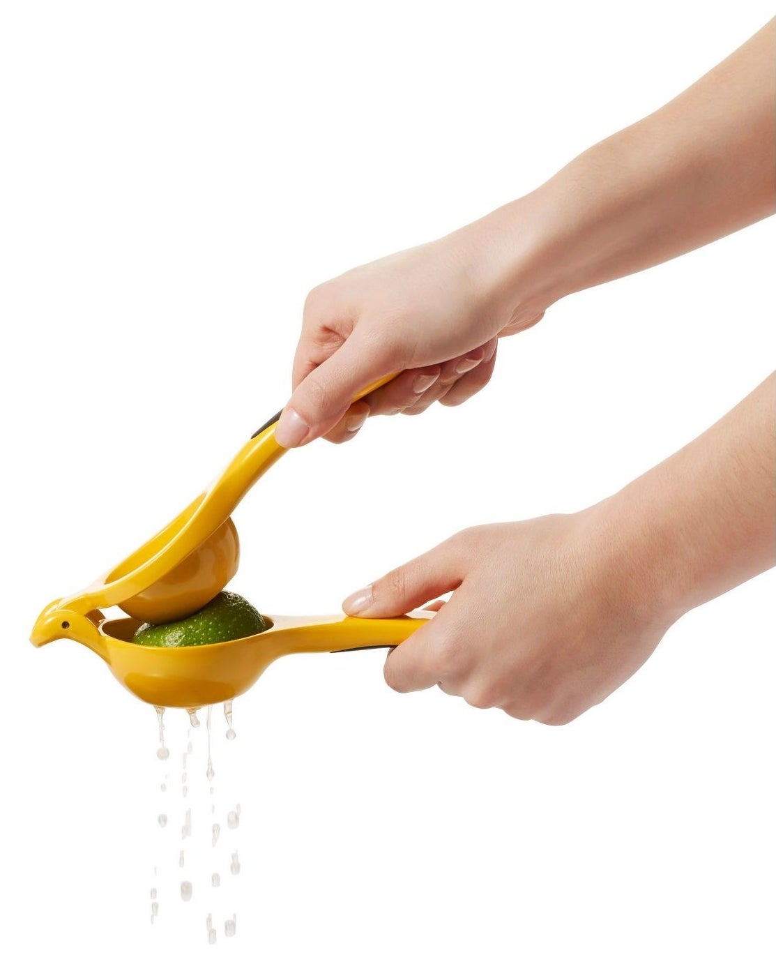 person using a citrus juicer to squeeze lime juice out of a lime