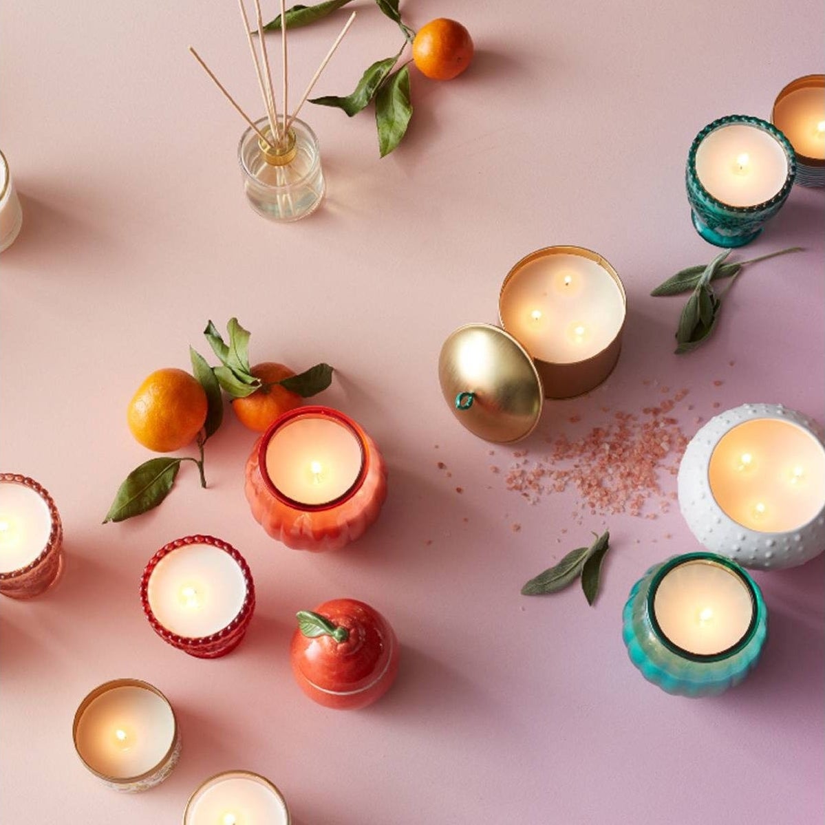 Opalhouse lidded candles with fruit and other jars on a light pink background