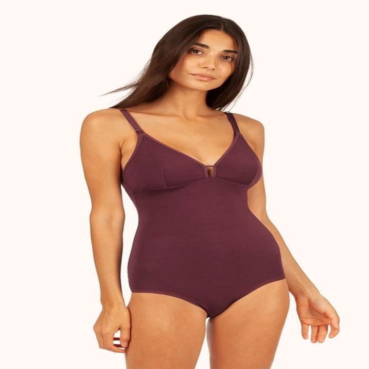 Person wearing maroon bodysuit bra with plunging neckline and spaghetti straps 