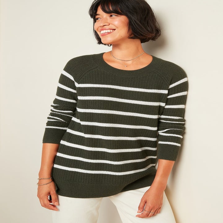 model in olive green sweater with white horizontal stripes
