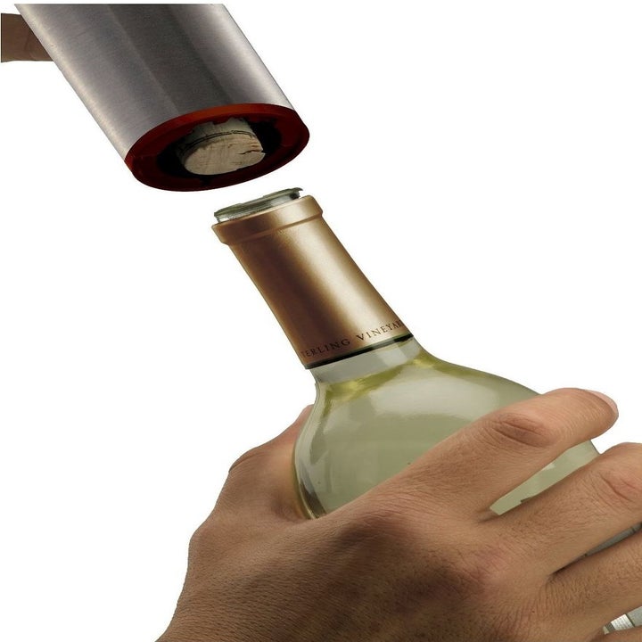electric wine opener uncorking a bottle of wine