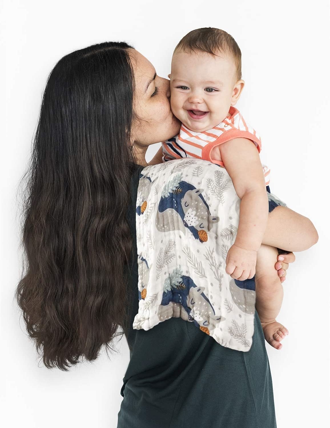 A parent holding their baby in their arms with a cloth over their shoulder