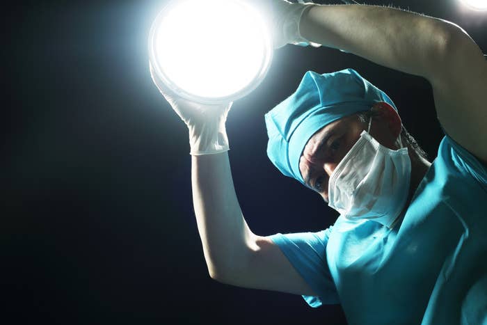 Surgeon holding up a lamp
