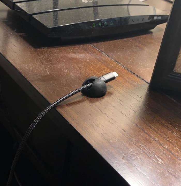 reviewer photo showing cable clip attached to their nightstand