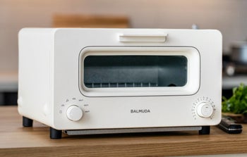 The white toaster which has a single dial on the lefthand side of the appliance