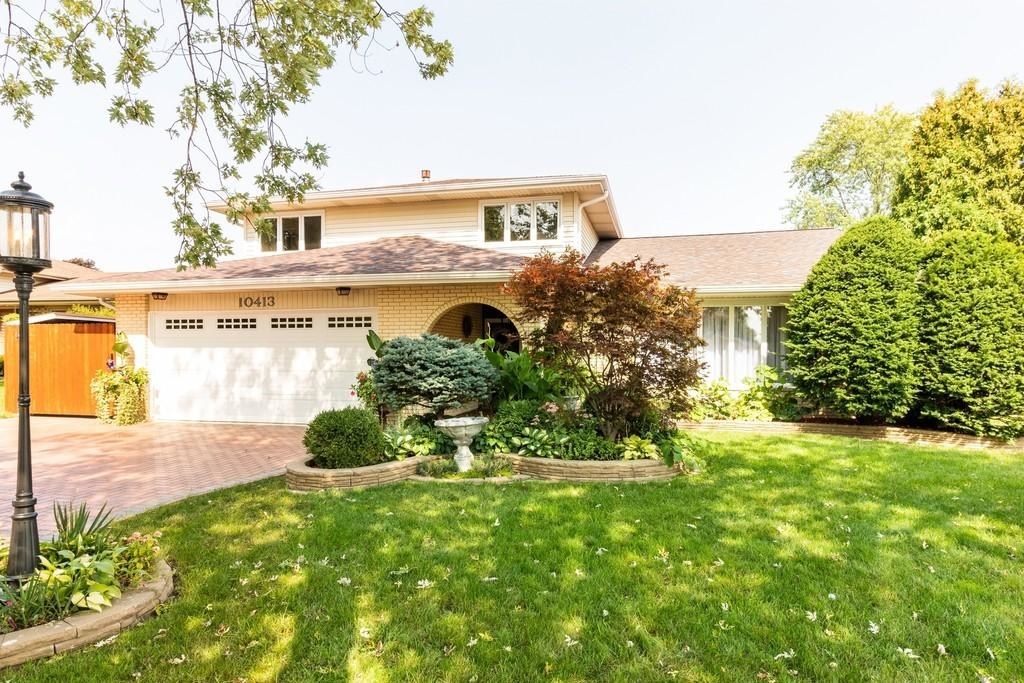 Sunny home with a lush green lawn