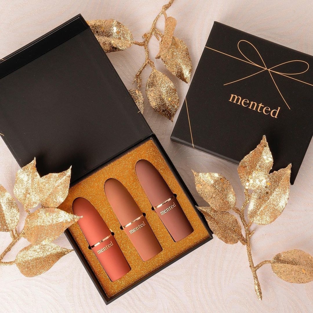 a gift box with three tubed of lipstick inside 