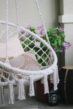 close up of the hammock swing with tassels hanging down from it 