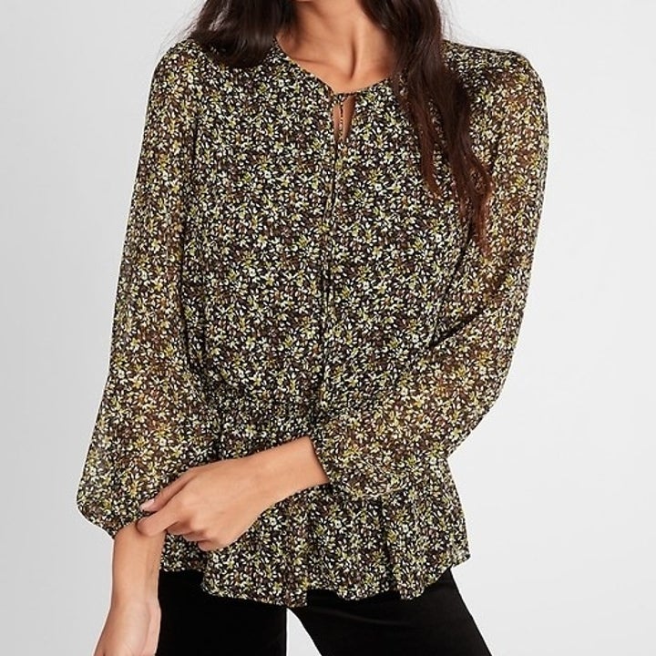 Model in black and yellow floral peplum top 