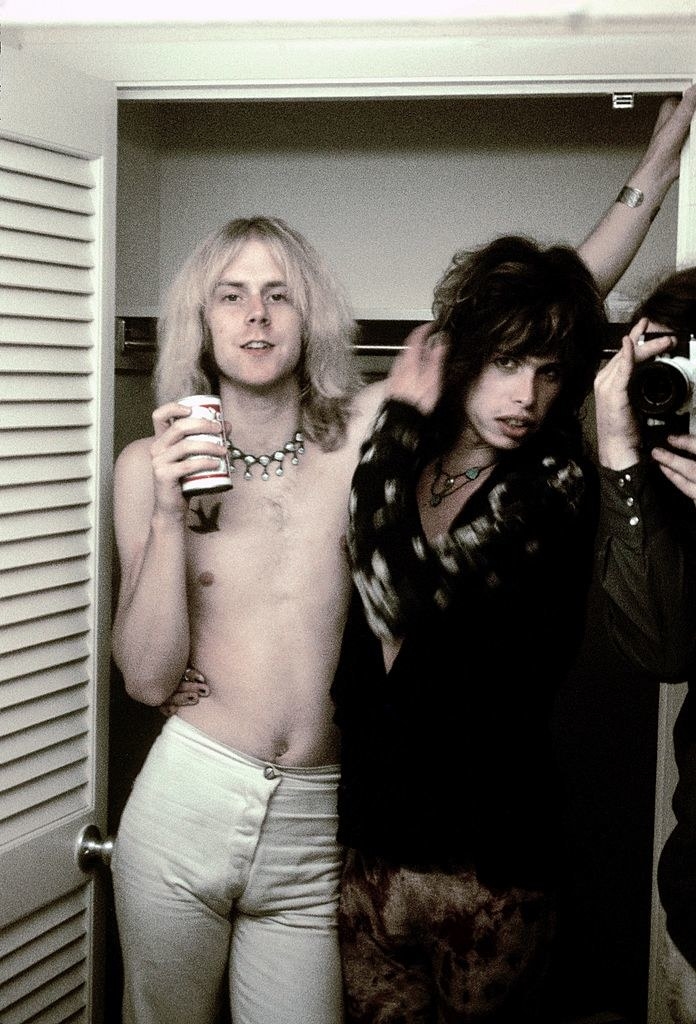 Tom Hamilton and Steven Tyler of Aerosmith posing backstage in 1973 