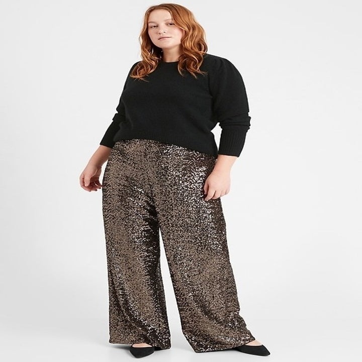 Model in flared silver sequin pant s