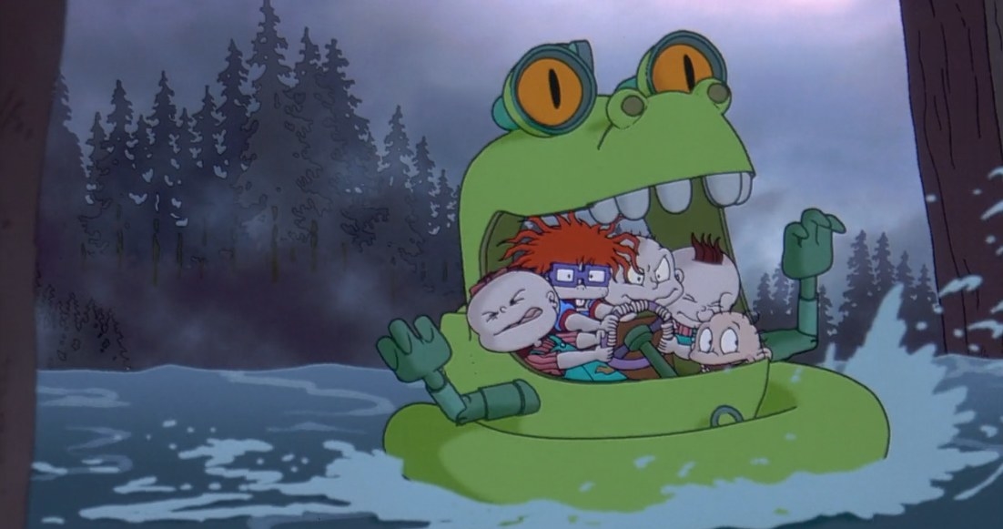 Lil, Chuckie, Tommy, Phil, and Dylan steering a Reptar vehicle.