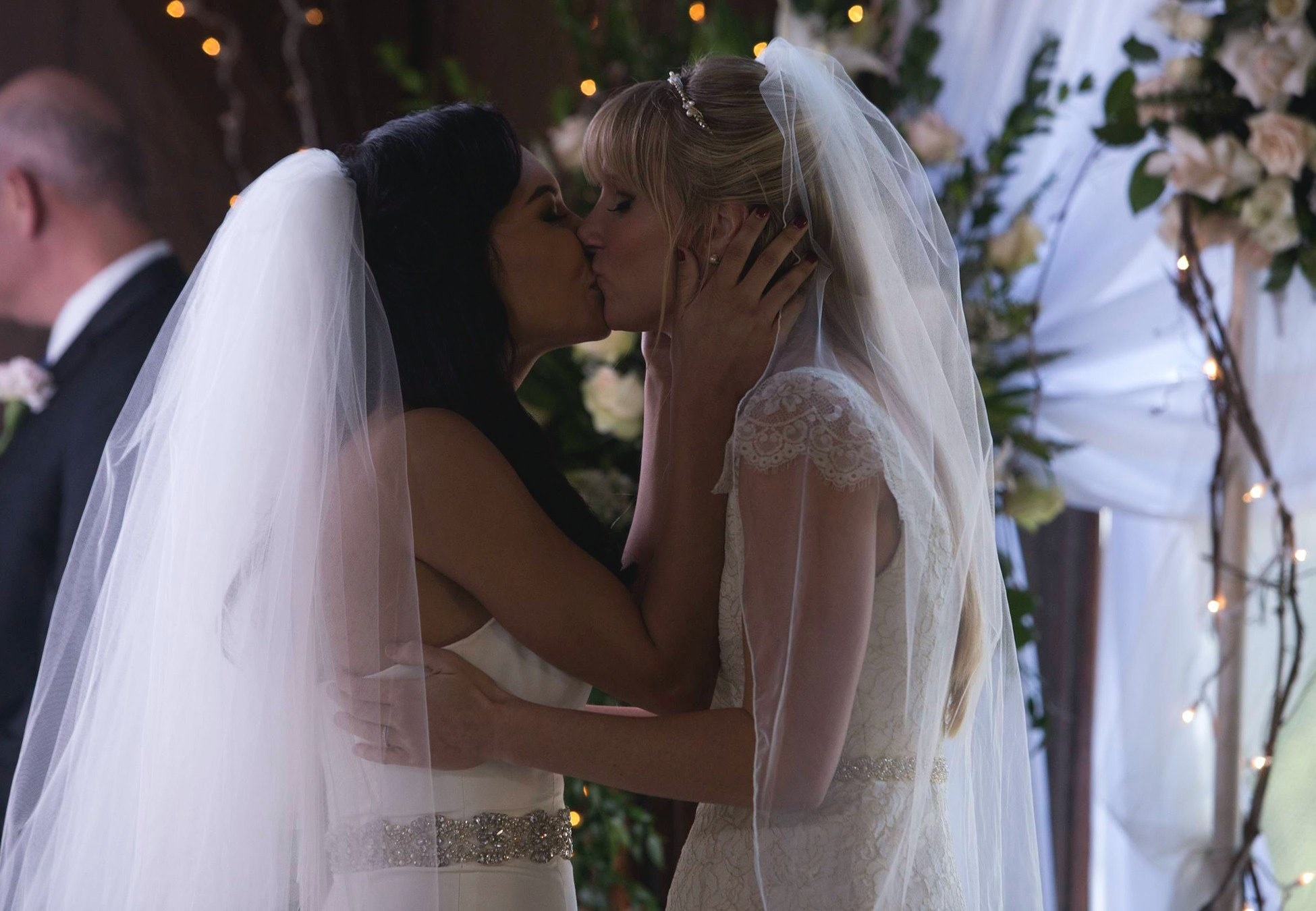 Santana and Brittany kissing at the top of the altar 